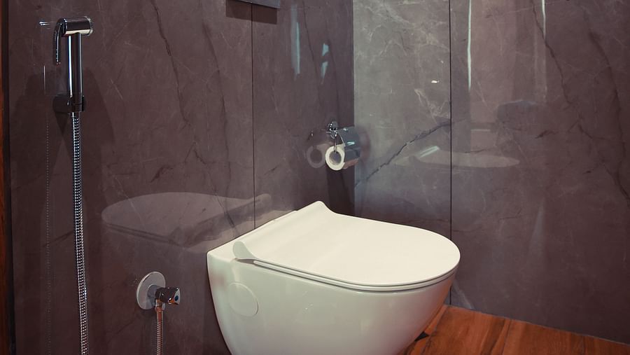 Deluxe King Room washroom with sleek fixtures and wooden paneling at Clarks Inn Suites Jaipur, Ajmer Road